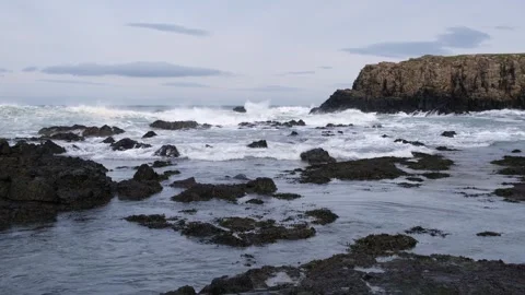 Atlantic Ocean waves breaking on shoreline at Dunseverick Northern Ireland Vídeos de archivo 303451383