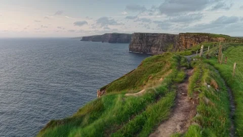 Atlantic ocean waves crash against steep stone walls at Cliffs of Moher Stock Footage 341754813