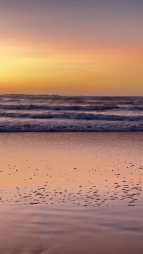 Atlantic Ocean waves rolling onto beach during colorful Portugal sunset 스톡 동영상 339062161
