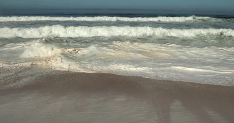 Atlantic Ocean Waves Rolling onto a Sandy Beach in Portugal Stock Footage 346035438