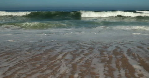 Atlantic Ocean Waves Rolling onto a Sandy Beach in Portugal Stock Footage 346035479