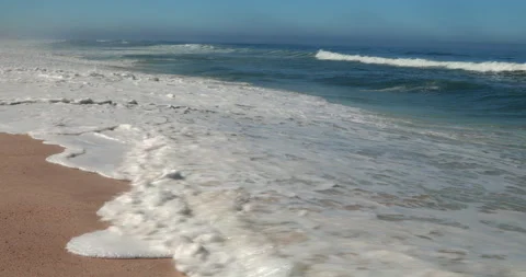 Atlantic Ocean Waves Rolling onto a Sandy Beach in Portugal Stock Footage 346054049