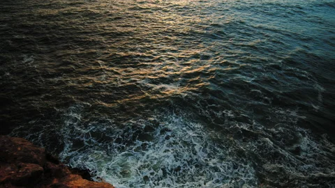 Atlantic Ocean waves in slow motion during golden sunset from a rocky seashore. Stock Footage 169658519