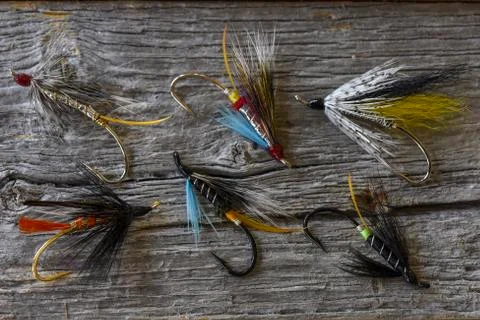 Atlantic salmon fly selection on weathered wood. Stock Photos