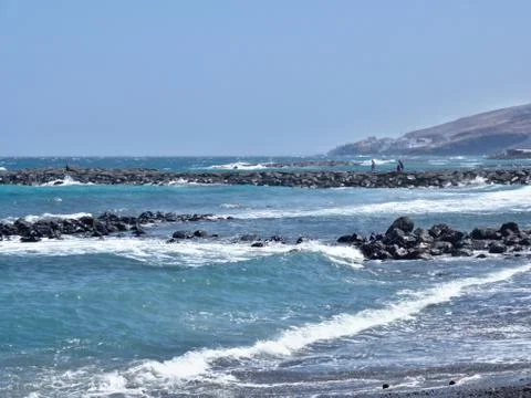 The Atlantic throws white foamy waves on the beach, wave breakers Stock Photos