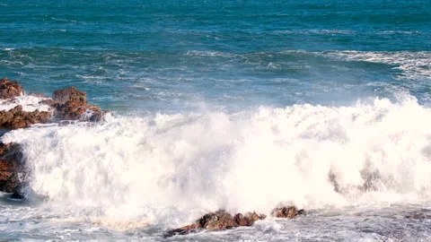 Atlantic wave crashes dramatically over coastal rocks Stock Footage 312327438
