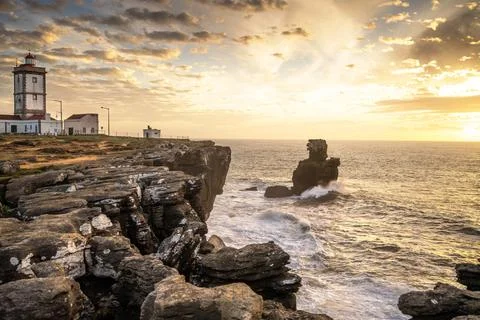 Atlantic waves and lighthouse cliffs at sunset in Peniche Stock Photos