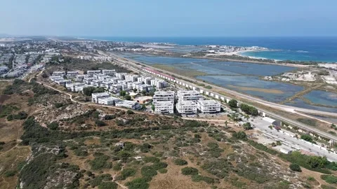Atlit Mediterranean town,red train moving to Tel Aviv, Israel,aerial view Stock Footage 312718122