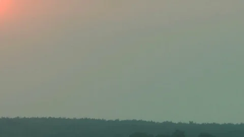The atmosphere and dense clouds have hidden the sun during a sunset. Видео 70289046