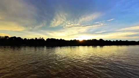 The atmosphere of the big river at dusk and the silhouette of the trees. 4K Stock Footage 296474620