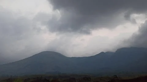 The atmosphere of black clouds approaching rain with a timelapse of Mount Thunde Stock Footage 302673586