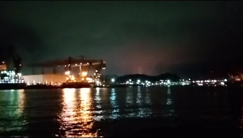 The atmosphere of the harbor can be seen from afar with a background of darkness Stock Footage 277306434