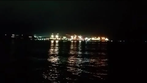 The atmosphere of the harbor can be seen from afar with a background of darkness Stock Footage 277306543