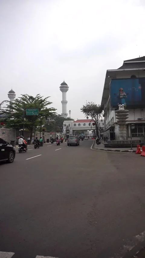 The atmosphere of motorized vehicle traffic passing along Jalan Asia Afrika Stock Footage 336740997