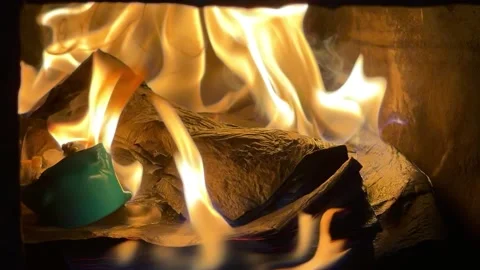 Atmospheric close-up of intense orange flames flickering in a fireplace Stock Footage 327806370