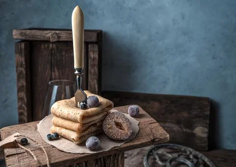 Atmospheric culinary background with pancakes and berries and a fork. Stock Photos