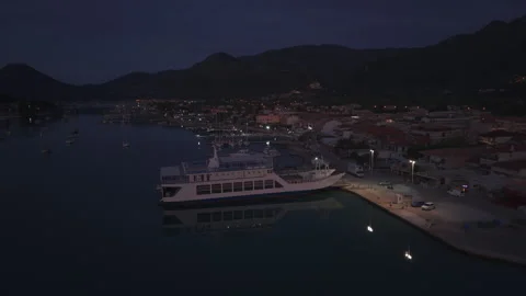 Atmospheric footage approaching a ferry docked in a quiet harbor before sunrise Stock Footage 336445826