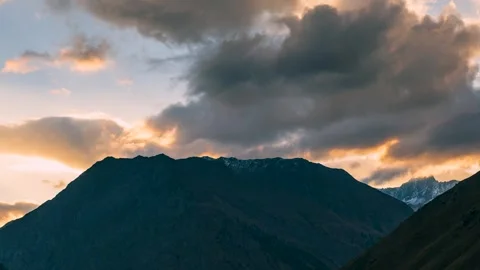 Atmospheric Nature Background of Orange Sunset and Dark Terrain Stock Footage 330440146