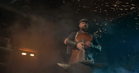Atmospheric portrait frame of a young blacksmith Stock Footage 145128348