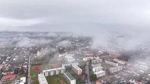 Atmospheric scene of low clouds and fog rolling over quiet residential dist.. Stock Photos