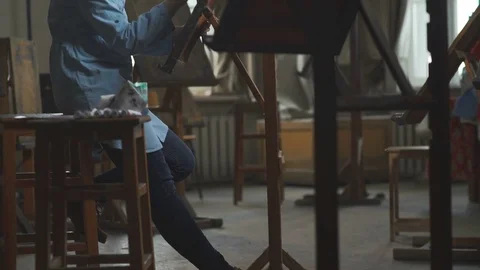 Atmospheric studio, artist's workshop and woman painter in blue dress Stock Footage 74996960
