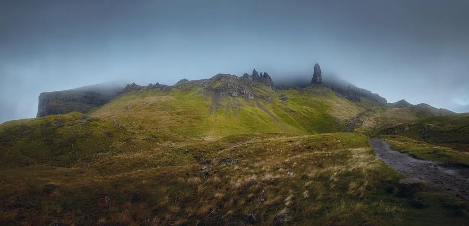 Atmospheric view of high sharp cliffs and the looming rain cloud Stock Photos