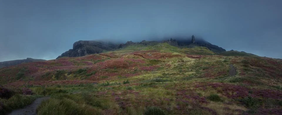Atmospheric view of high sharp cliffs and the looming rain cloud Stock Photos
