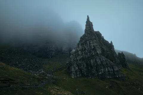 Atmospheric view of high sharp cliffs covered in fog Stock Photos