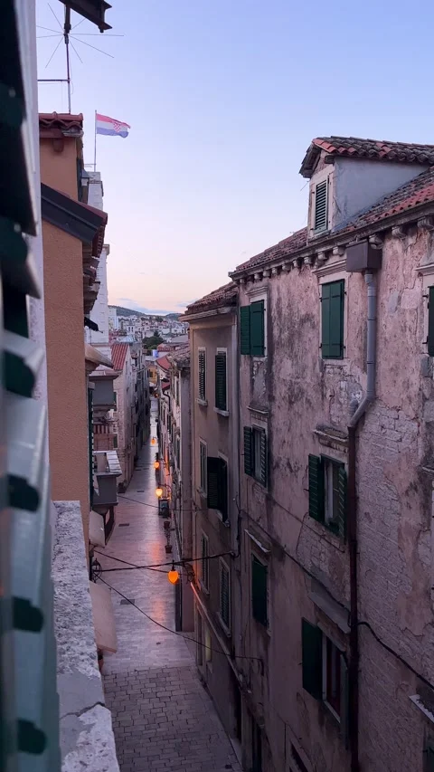 Atmospheric View from a window down of a narrow, historic street with national Stock Footage 315293905