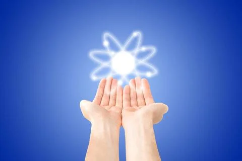 Atom structure model in hands Atom structure model in hands with nucleus a... Stock Photos