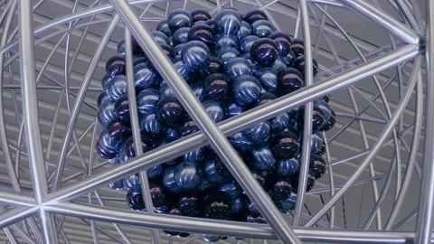 An atomic structure made of large rings and a balls symbolizing protons Stock Footage 323838895