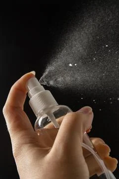 Atomizer in use hold in hand Stock Photos