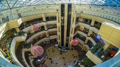 The atrium space of the mall. The movement of shoppers, elevators and escalat Stock Footage 172269051