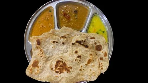 Atta Rotti with three different curry's Stock Photos