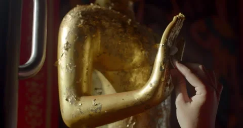 Attach a gold plate to your hand on the Buddha image. Stock Footage 310630912