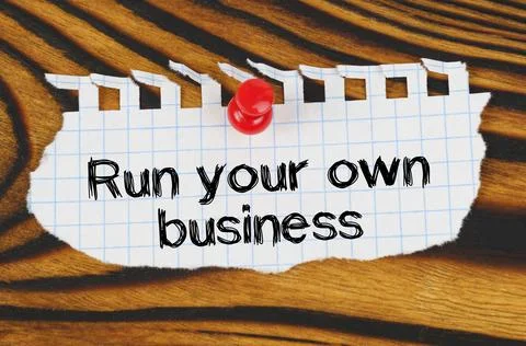 Attached to the board is an announcement with the inscription - Run your own  Stock Photos
