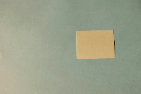 Attached yellow note with free text blue background Stock Photos