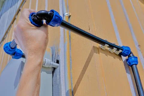 Attaching an angle pipe fitting with a compression threaded clamp to domestic Foto stock