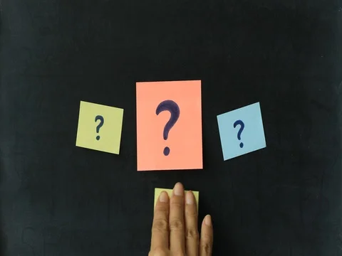 Attaching colorful post it with question mark on blackboard Stock Footage 80850693