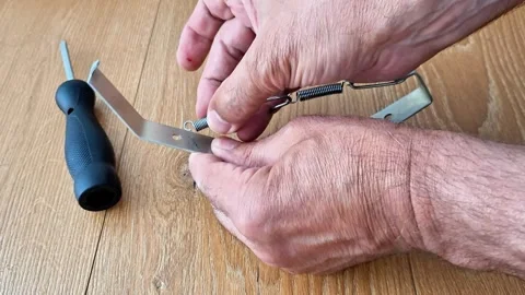 Attaching an Extension Spring to a Metal Hook by Hand Stock Footage 340541031
