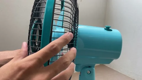 Attaching front and rear grille metal bar to electric fan. DIY assemble safety Stock Footage 188514549