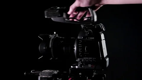 Attaching Handle to Cinema Camera Canon C100 Vídeo Stock 72972636