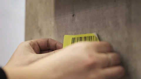 Attaching a Logistics Scanner Barcode Sticker to a Concrete Wall and Scanning It 스톡 동영상 118547430