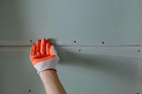 Attaching  mesh to the plasterboards. Stock Photos