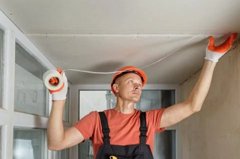 Attaching  mesh to the plasterboards. Stock Photos