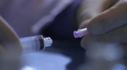 Attaching needle to syringe Stock Footage 20447444