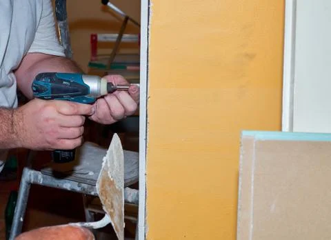 Attaching a part of a plasterboard Stock Photos