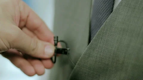 Attaching of a studio microphone to a jacket Stockbeeldmateriaal 2367987