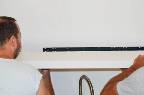 Attaching a wall shelf Stock Photos