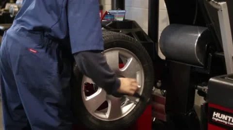 Attaching Wheel to Balancing Machine Stock Footage 10561843